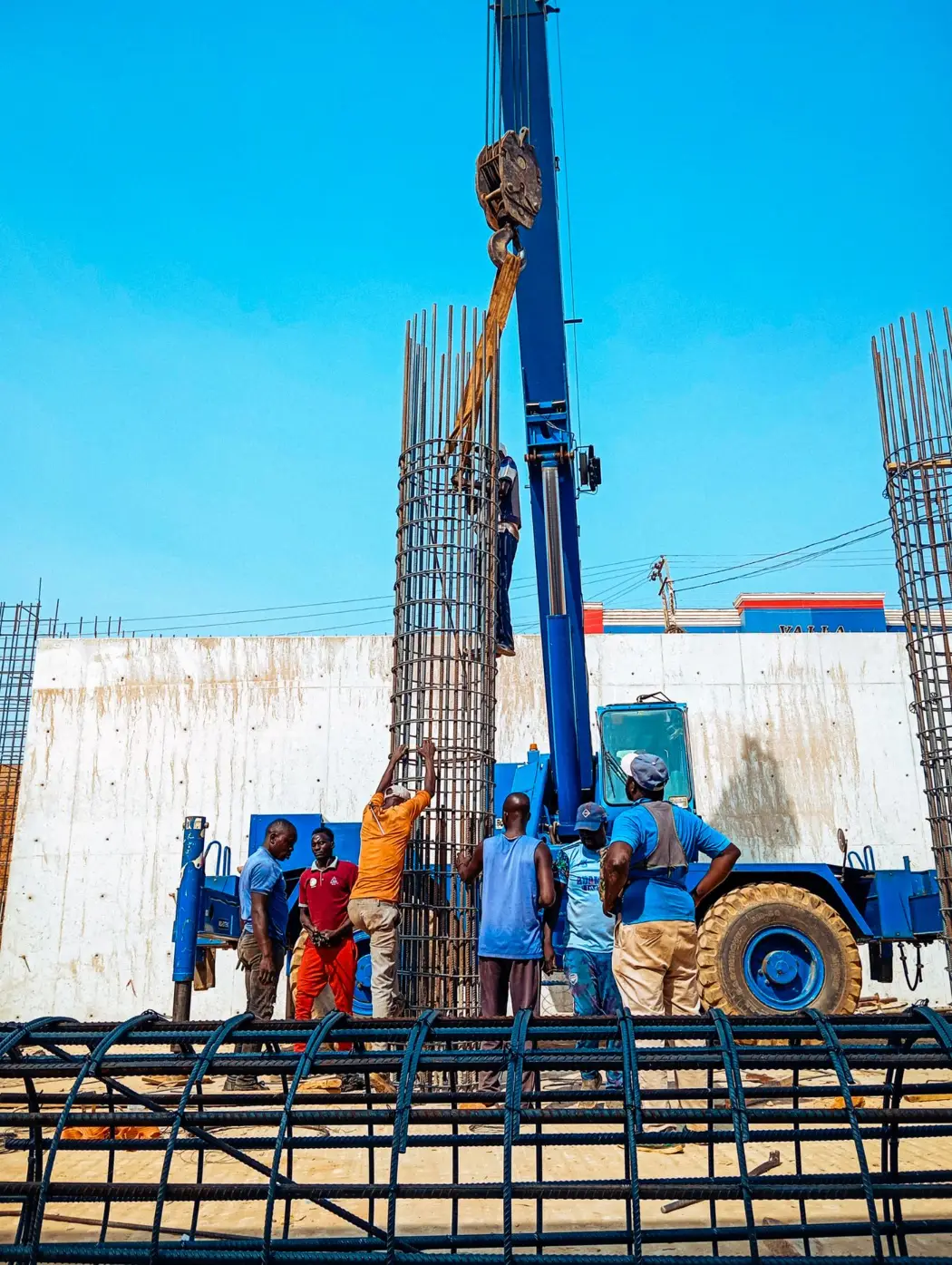 Builders raising reinforced columns on a site in Jimeta
