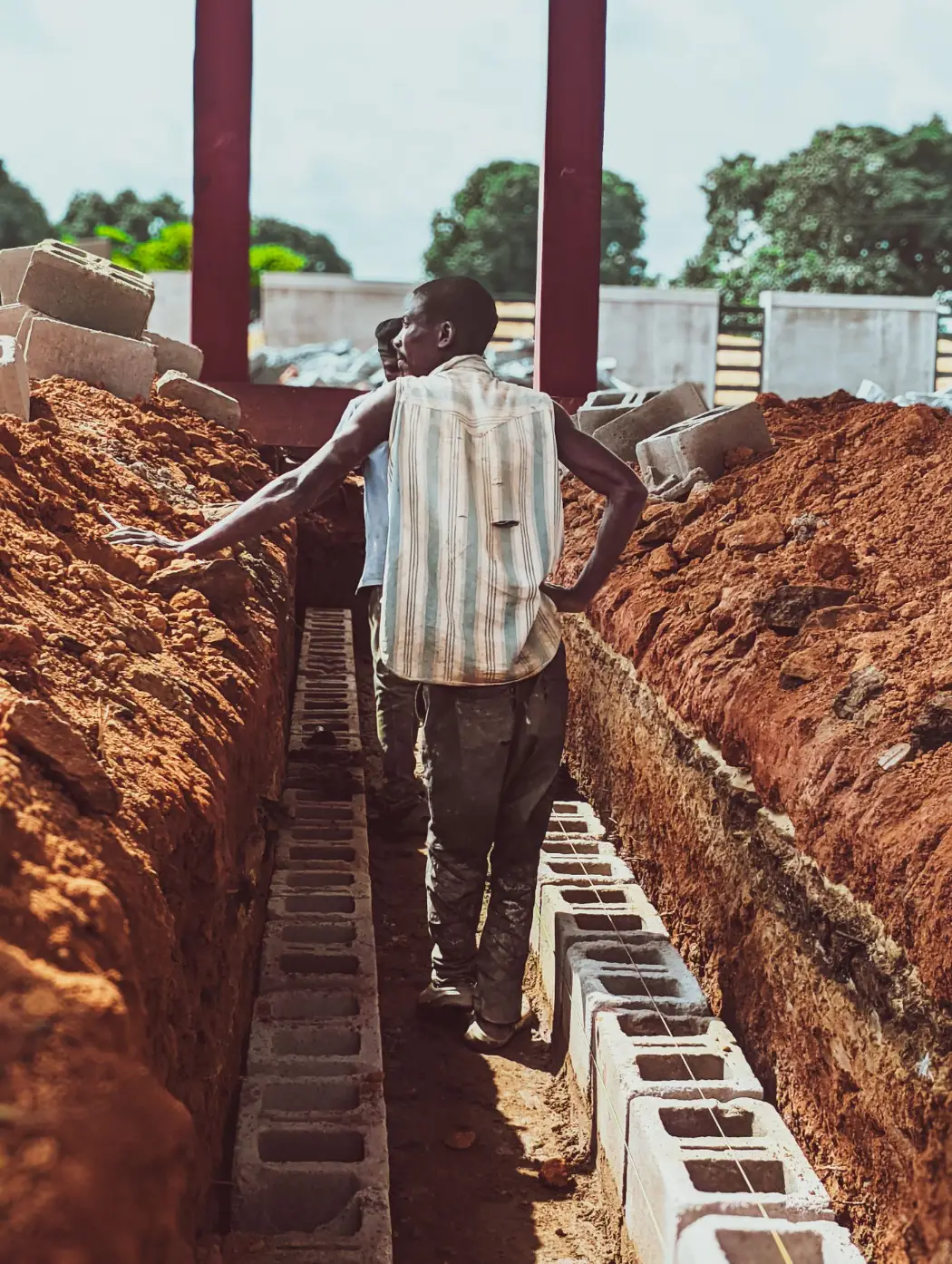 Workers laying foundation blocks on a building site in Kaduna