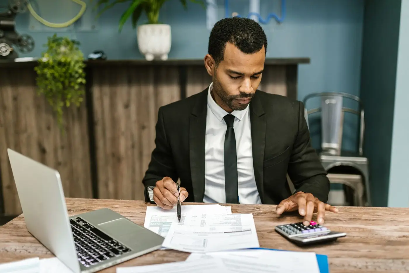 An accountant working through figures with a calculator