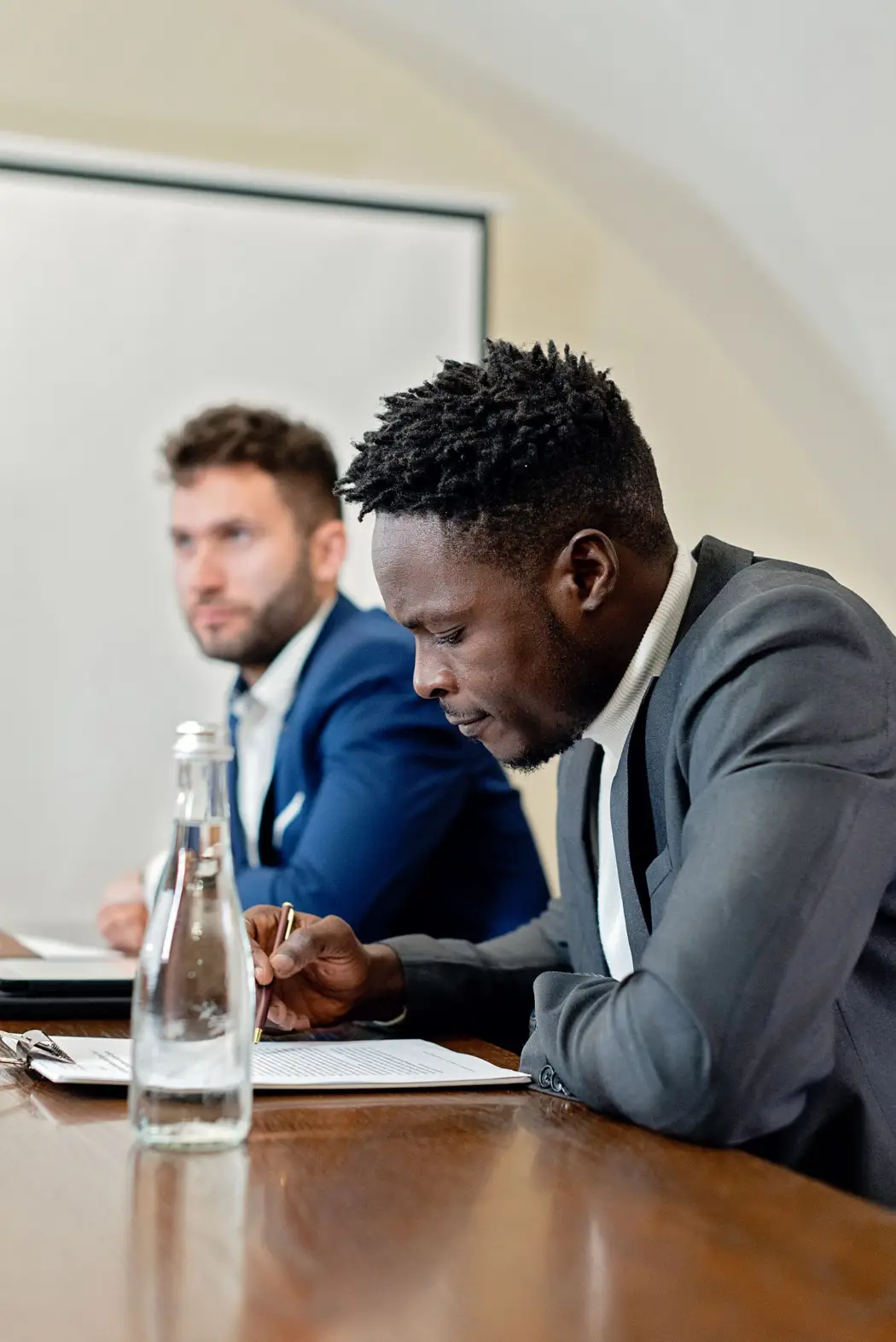 Two professionals reviewing documents in a meeting